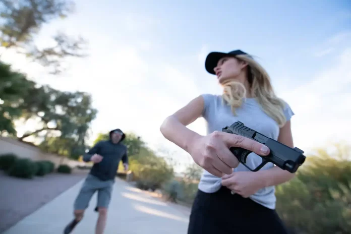 woman-draws-a-pistol-when-she-is-confronted-by-a-lethal-threat-while-jobbing.jpg.webp.webp